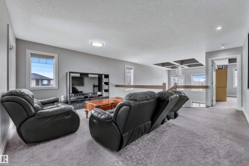 Upper level bonus room featuring neutral carpeting, light gray wall tones, and white trim - 3702 Claxton Place, Edmonton, AB - Indoor