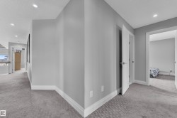 Corridor featuring neutral wall tones and recessed lighting - 