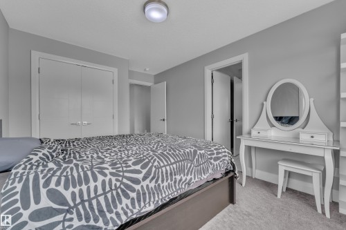 Interior room featuring light gray wall paint, light-colored carpeting, a flush-mount ceiling light fixture, and white trim - 3702 Claxton Place, Edmonton, AB - Indoor Photo Showing Bedroom