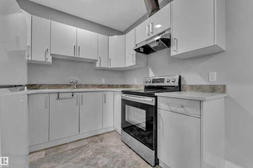 Kitchen featuring white cabinetry, stone-finish countertops, stainless steel electric range, and integrated sink - 3702 Claxton Place, Edmonton, AB - Indoor Photo Showing Kitchen