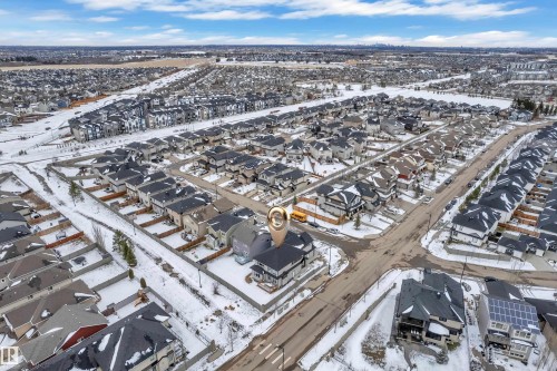 Aerial view of a residential community featuring numerous single-family homes with dark roofs - 3702 Claxton Place, Edmonton, AB - Outdoor With View