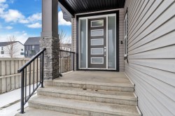 Modern entry featuring a gray door with five frosted glass panels and a full-light sidelight - 