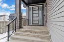 Modern entry featuring a gray door with five frosted glass panels and a full-light sidelight - 3702 Claxton Place, Edmonton, AB  - Outdoor With Exterior 