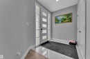 Modern entryway featuring a white paneled door with frosted glass inserts and corresponding sidelights - 3702 Claxton Place, Edmonton, AB  - Indoor Photo Showing Other Room 