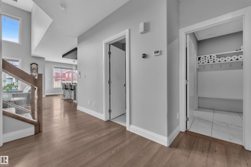Hardwood-style flooring throughout the main level - 3702 Claxton Place, Edmonton, AB - Indoor Photo Showing Other Room