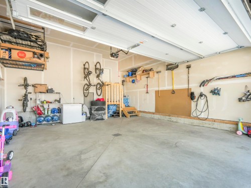Spacious garage featuring a concrete floor, overhead storage racks, and wall-mounted organization systems - 19 Nettle Crescent, St. Albert, AB - Indoor Photo Showing Garage