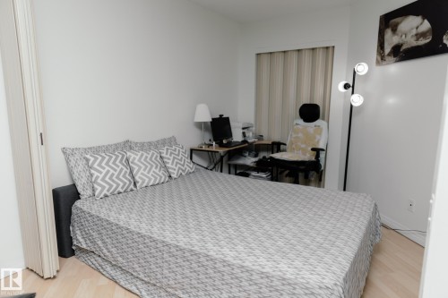 The property includes a room with light-colored flooring, white walls, and a closet with bifold doors - 42 11245 31 Avenue, Edmonton, AB - Indoor Photo Showing Bedroom