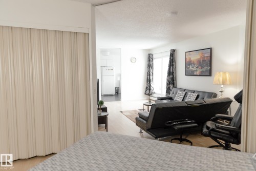 The open concept living area features light-colored flooring and white walls, creating a bright atmosphere - 42 11245 31 Avenue, Edmonton, AB - Indoor Photo Showing Bedroom