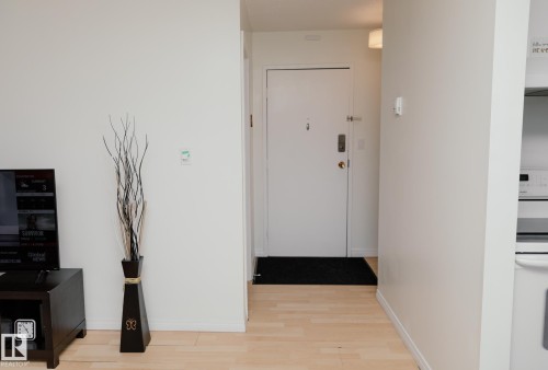 Entryway with light hardwood flooring and a white door with modern hardware - 42 11245 31 Avenue, Edmonton, AB - Indoor Photo Showing Other Room