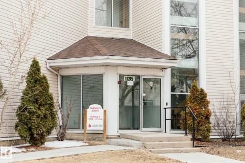 The property features an entrance with a covered porch, a glass paneled door, and large windows - 42 11245 31 Avenue, Edmonton, AB - Outdoor