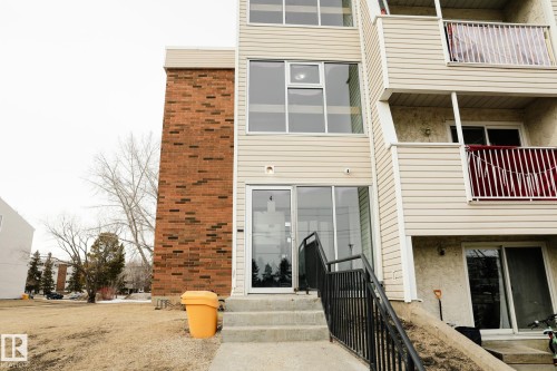 The property features a brick exterior accent and siding, with balconies and large windows providing natural light - 42 11245 31 Avenue, Edmonton, AB - Outdoor With Balcony