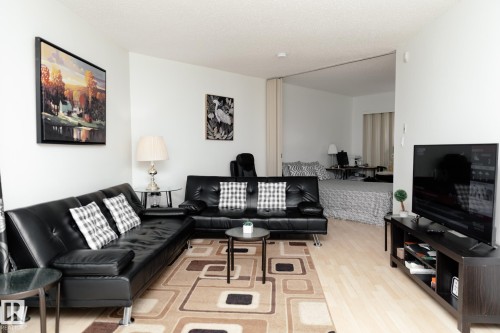 The open concept living area features light-colored flooring and white walls, creating a bright and airy atmosphere - 42 11245 31 Avenue, Edmonton, AB - Indoor Photo Showing Living Room