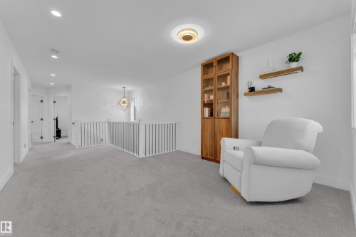 Spacious upper-level landing with light gray carpeting - 9 Hunter Place, Spruce Grove, AB - Indoor Photo Showing Other Room