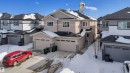 Contemporary duplex with a beige siding exterior and dark shingled roof - 9 Hunter Place, Spruce Grove, AB  - Outdoor With Facade 