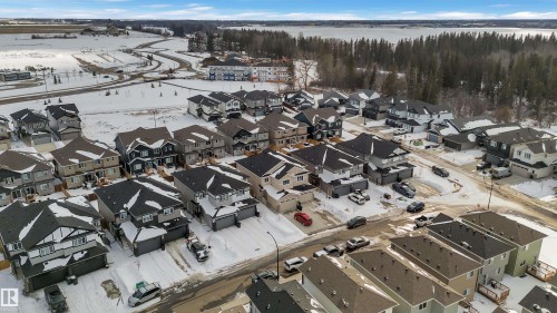 Aerial perspective of a developed residential area with snow-covered grounds - 9 Hunter Place, Spruce Grove, AB - Outdoor With View
