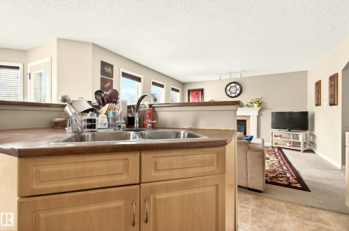 Kitchen sink with a dual basin and chrome faucet, set into a laminate countertop - 8922 5Av, Edmonton, AB - Indoor Photo Showing Kitchen With Double Sink