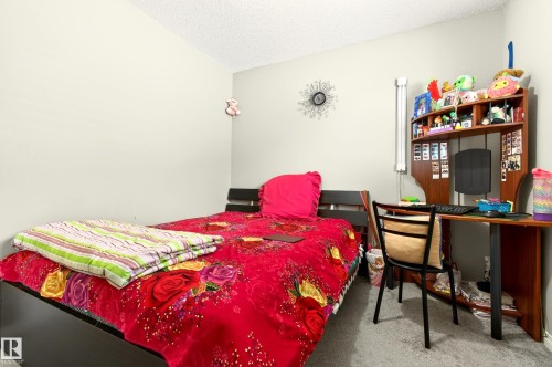 Light-colored walls with a textured ceiling - 8922 5Av, Edmonton, AB - Indoor Photo Showing Bedroom