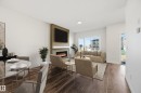 243 Wattle Road, Leduc, AB  - Indoor Photo Showing Dining Room With Fireplace 