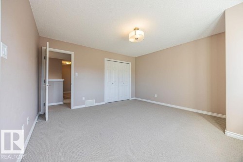 Carpeted room with neutral wall tones and a textured ceiling - 14 9350 211 Street, Edmonton, AB - Indoor Photo Showing Other Room