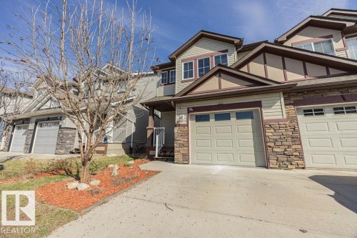 Exterior featuring stone veneer accents, horizontal siding, and multiple gables - 14 9350 211 Street, Edmonton, AB - Outdoor With Facade