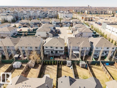 Aerial perspective showcasing multiple residential properties with pitched roofs, individual backyards, and established fencing - 14 9350 211 Street, Edmonton, AB - Outdoor With View
