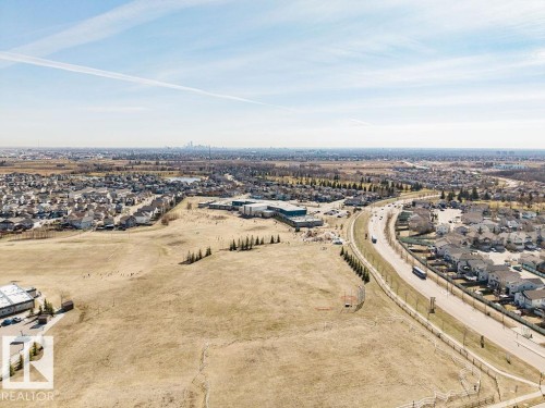 Expansive land parcel offering significant development potential, bordered by established residential areas and a prominent roadway - 14 9350 211 Street, Edmonton, AB - Outdoor With View