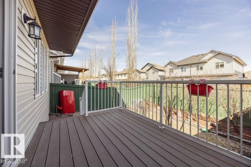 Elevated deck featuring composite decking and white metal railings - 14 9350 211 Street, Edmonton, AB - Outdoor With Deck Patio Veranda With Exterior