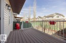 Elevated deck featuring composite decking and white metal railings - 14 9350 211 Street, Edmonton, AB  - Outdoor With Deck Patio Veranda With Exterior 
