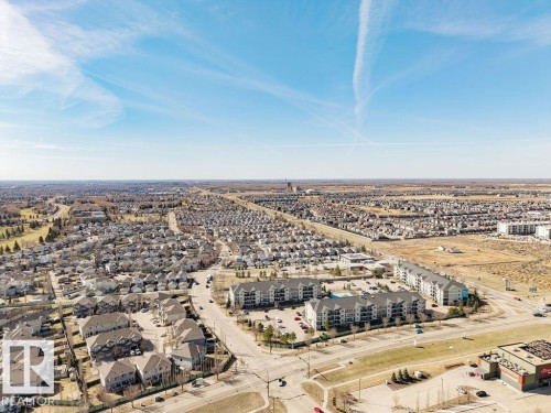 Aerial perspective showcasing a developed residential area with single-family homes and multi-story apartment buildings - 14 9350 211 Street, Edmonton, AB - Outdoor With View