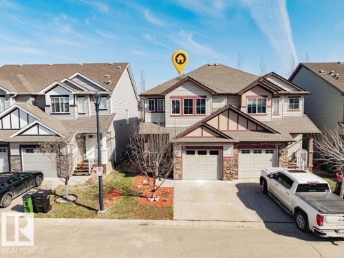 Two-story residence featuring a combination of siding and stone veneer - 14 9350 211 Street, Edmonton, AB - Outdoor With Facade