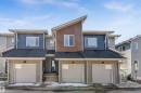 Contemporary townhome exterior featuring multi-toned siding, a dark asphalt shingle roof, and an integrated single-car garage - 48 710 Mattson Drive, Edmonton, AB  - Outdoor With Exterior 