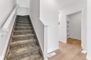 Carpeted staircase with white handrail and trim - 48 710 Mattson Drive, Edmonton, AB  - Indoor Photo Showing Other Room 
