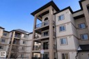 The property features a multi-story building with balconies, a tan and brown exterior, and multiple windows - 324 13111 140 Avenue, Edmonton, AB  - Outdoor With Balcony 