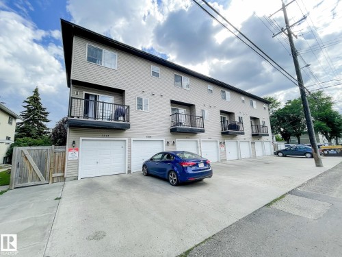 Multi-level residential building featuring light-colored siding and a contrasting dark fascia - 5806 118 Avenue Nw, Edmonton, AB - Outdoor