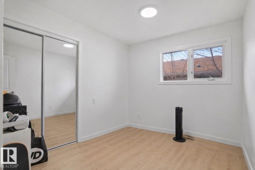 Room featuring light wood-finish flooring and white baseboards - 1566 Lakewood Road Nw, Edmonton, AB - Indoor Photo Showing Other Room