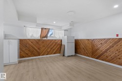 Lower-level room featuring wood-finish flooring and a white ceiling - 