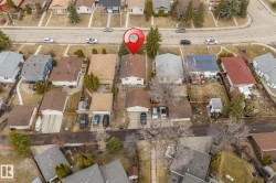 Aerial perspective of a residential property within a neighborhood setting, featuring a rear yard space - 