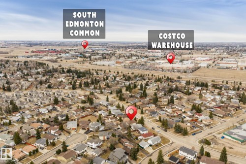 Aerial perspective of a residential area featuring single-family homes and mature trees - 1566 Lakewood Road Nw, Edmonton, AB - Outdoor With View