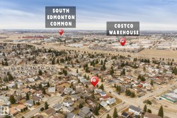 Aerial perspective of a residential area featuring single-family homes and mature trees - 