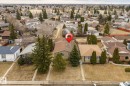 Single-story dwelling with a brown shingle roof, light-colored siding, and mature evergreen trees flanking the front - 1566 Lakewood Road Nw, Edmonton, AB  - Outdoor With View 