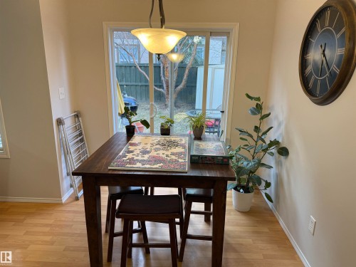 Dining area featuring light wood-finish flooring and a contemporary pendant light fixture - 97 2021 Grantham Crest, Edmonton, AB - Indoor Photo Showing Dining Room