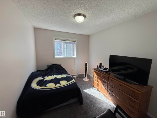 Compact room featuring light-colored walls and textured ceiling - 97 2021 Grantham Crest, Edmonton, AB - Indoor Photo Showing Bedroom