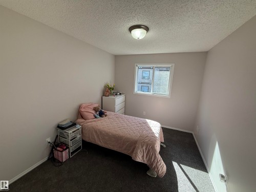 Interior space featuring neutral wall paint, dark carpet flooring, and a single window with white trim - 97 2021 Grantham Crest, Edmonton, AB - Indoor Photo Showing Bedroom