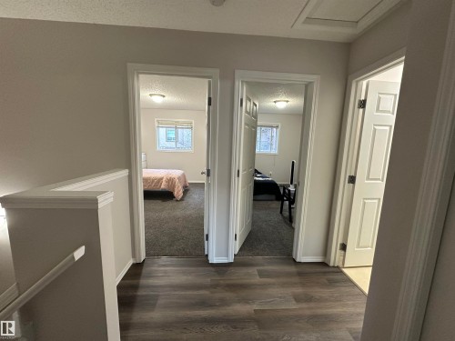 Hallway featuring wood-finish flooring, light grey painted walls, and white trim - 97 2021 Grantham Crest, Edmonton, AB - Indoor Photo Showing Other Room