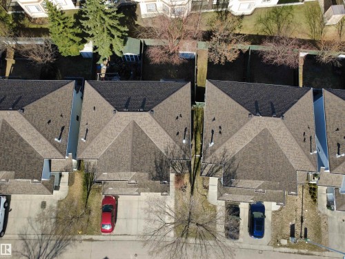 Aerial perspective showcasing multiple properties, each featuring brown shingle roofing and individual driveways - 97 2021 Grantham Crest, Edmonton, AB - Outdoor
