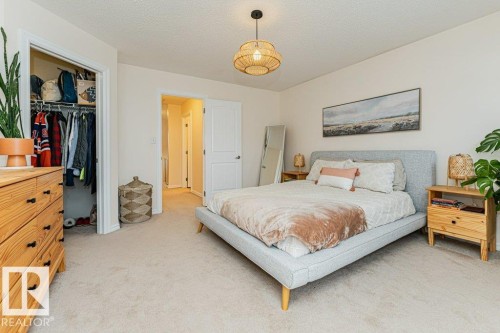 Bedroom featuring light-colored carpeting, a ceiling light fixture, and a closet with a built-in hanging rod - 2828 21 Avenue, Edmonton, AB - Indoor Photo Showing Bedroom