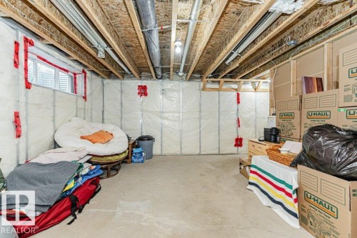The property features an unfinished basement with exposed ceiling joists and visible insulation - 2828 21 Avenue, Edmonton, AB - Indoor Photo Showing Basement