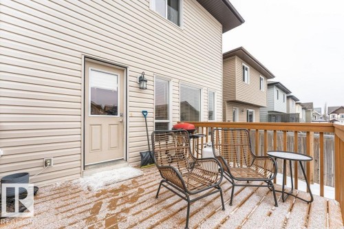 The property features a private deck with wooden railings, providing outdoor space - 2828 21 Avenue, Edmonton, AB - Outdoor With Deck Patio Veranda With Exterior