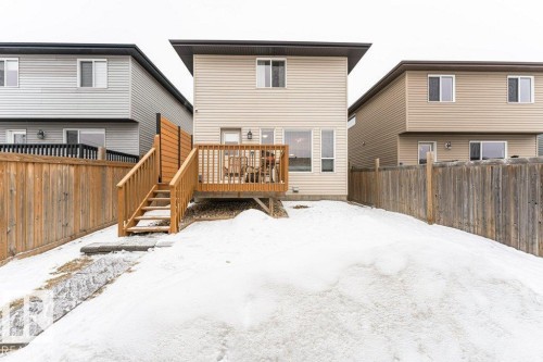The property features a wooden deck with railing and stairs, offering outdoor space - 2828 21 Avenue, Edmonton, AB - Outdoor With Deck Patio Veranda With Exterior