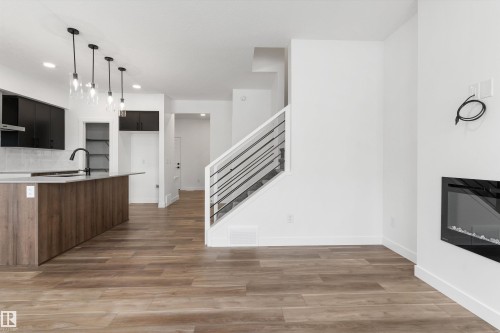 1755 Westerra Wynd, Stony Plain, AB - Indoor Photo Showing Kitchen With Fireplace
